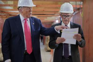 U.S. President Donald Trump presents Federal Reserve Chair Jerome Powell with what he Trump called a list of cost overruns for the Federal Reserve’s $2.5 billion headquarters renovation project on July 24, 2025, in Washington, D.C. (Chip Somodevilla/Getty Images/TNS)