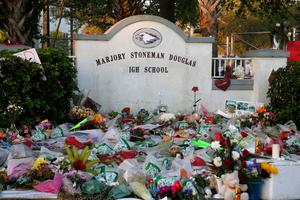 Flowers, candles and mementos sit outside one of the makeshift memorials at Marjory Stoneman Douglas High School in Parkland, Florida on February 27, 2018. Florida's Marjory Stoneman Douglas high school will reopen on February 28, 2018 two weeks after 17 people were killed in a shooting by former student, Nikolas Cruz, leaving 17 people dead and 15 injured on February 14, 2018. / AFP PHOTO / RHONA WISE (Photo credit should read RHONA WISE/AFP via Getty Images)