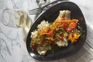 A saute of sweet peppers, tomatoes and onions over pan-seared cod hits the spot. (JeanMarie Brownson/TCA)