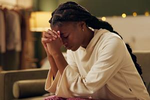 Woman praying. Dreamstime/TCA