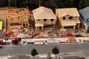 In an aerial view, construction workers build a home at a new housing development on July 1, 2025, in Hercules, California. According to a report by the U.S. Commerce Department's Census Bureau, U.S. construction spending fell 0.3% in May as higher mortgage rates and rising inventory impacted single-family housing projects. (Justin Sullivan/Getty Images/TNS)
