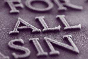 The words FOR ALL SIN coated in frost on a plaque. Dreamstime/TCA