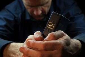 Man and bible. Dreamstime/TCA