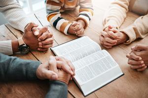 Kids reading Bible. Dreamstime/TCA