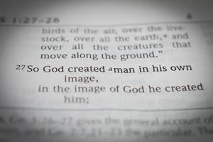 Black and white macro photo of one the most famous bible verses: Genesis 1:27 So God created man in his own image. Dreamstiome/TCA