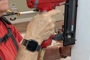 I’m using one of my favorite tools of all time: a pneumatic gun that fires thin finish nails and countersinks them too! (Tim Carter/Tribune Content Agency)