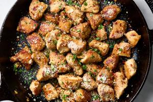 Tender, bite-sized pieces of chicken flavored with garlic and a generous shower of nutty Parmesan. (Alex Lepe/TCA)