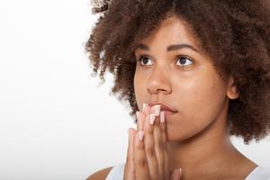 Woman praying. Dreamstime/TCA