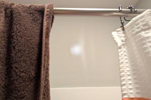 The reflection on the wall above the shower is caused by invisible condensation on the flat wall paint. Hot, steamy showers feed mold growth in your bathroom. (Tim Carter/Tribune Content Agency/TNS)