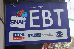 NEW YORK, NEW YORK - OCTOBER 30: An EBT sign is displayed on the window of a grocery store on October 30, 2025 in the Flatbush neighborhood of the Brooklyn borough in New York City.  Supplemental Nutrition Assistance Program (SNAP) benefits and other assistance are set to stop on November 1st amid a federal government shutdown that has been going on for 29 days and is the second-longest shutdown in the nation's history. New York Gov. Kathy Hochul declared a state of emergency for extra emergency funds and personnel to be deployed, as SNAP payments will be suspended. About 42 million Americans are expected to lose access to their benefits. (Photo by Michael M. Santiago/Getty Images)