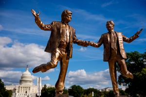WASHINGTON, DC - OCTOBER 2: The Dome of the U.S. Capitol Building is visible behind a statue depicting U.S. President Donald Trump and Jeffrey Epstein holding hands on the National Mall on October 2, 2025 in Washington, DC. The bronze-painted statue titled 