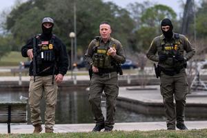 U.S. Customs and Border Patrol Commander Gregory Bovino, middle, flanked by fellow agents, leaves a park after interviewing residents during operations at a park in Metairie, Louisiana, on Dec. 5, 2025. (Adam Gray/AFP/Getty Images/TNS)