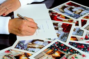 Writing out Christmas cards. Dreamstime/TCA