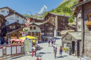 Zermatt is often socked in by clouds — but if you’re lucky to be there on a clear day, you’ll see the Matterhorn peeking out above the chalet rooftops and surrounding hills. (Rick Steves’ Europe)