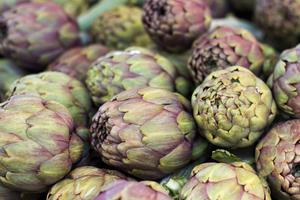 Choose artichokes that are heavy and firm with healthy green, closed center leaves. (Dreamstime/TCA)