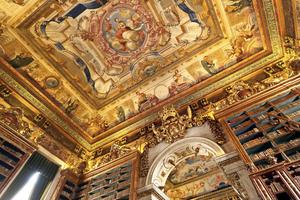 The painted ceiling of King João’s Library at Portugal’s University of Coimbra is an example of the Baroque illusion technique called trompe l’oeil. (Dominic Arizonia Bonuccelli, Rick Steves’ Europe)