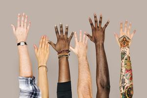Diversity hands raised up gesture. Dreamstime/TCA