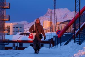 Daily life on a street at sunset in Nuuk, Greenland, on Jan. 21, 2026.  AP Photo/Evgeniy Maloletka