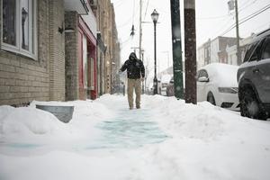 Conservation organizations recommend using one 12-ounce coffee mug of deicer for every 10 sidewalk squares. Joe Lamberti/Getty Images News via Getty Images