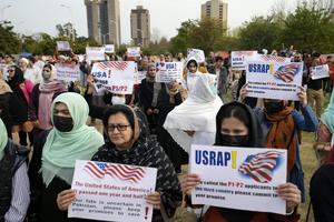 Afghan refugees hold placards during a protest in Islamabad, Pakistan, on Feb. 26, 2023. AP Photo/Rahmat Gul