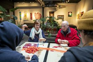 In Detroit, Mich., volunteers with the Detroit People's Assembly put together whistle kits designed to alert the community when immigration agents are nearby.  Jim West/UCG/Universal Images Group via Getty Images