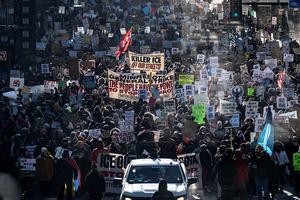 TOPSHOT - Protesters against Immigration and Customs Enforcement (ICE) march through the streets of downtown Minneapolis, Minnesota, on January 25, 2026. On January 24, federal agents shot dead US citizen Alex Pretti, a 37-year-old ICU nurse, while scuffling with him on an icy roadway, less than three weeks after an immigration officer shot and killed Renee Good, also 37, in her car. His killing sparked new protests and impassioned demands by local leaders for the Trump administration to end its operation in the city. (Photo by ROBERTO SCHMIDT / AFP via Getty Images)