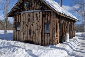 The black blotches visible on this building are not mold and mildew. The owner used a large propane-fueled blowtorch to char the siding. Charred wood resists insects, rot and ultraviolet light damage. (Tim Carter/Tribune Content Agency)
