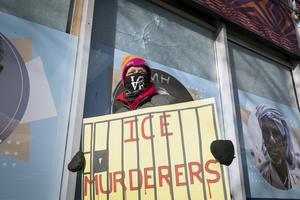 Sue, a woman who came to Minneapolis from Chicago to join the anti ICE protests carries a poster past window panels showing two gun perforations on Jan. 26, 2026, that according to the business owner said were made when Alex Pretti was gunned down by federal agents in Minneapolis on Jan. 24, 2026. A makeshift memorial at the shooting scene has been the center of attention for well wishers. A makeshift memorial at the shooting scene has been the center of attention for well wishers. On Jan. 24, federal agents shot and killed Alex Pretti, a 37-year-old ICU nurse, while scuffling with him on an icy roadway in Minneapolis, less than three weeks after an immigration officer fired on Renee Good, also 37, killing her in her car. U.S. President Donald Trump blamed their deaths on Democratic 
