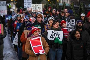 People take part in an anti-ICE protest outside the governor's residence in St. Paul, Minn., on Feb. 6, 2026.  AP Photo/Ryan Murphy