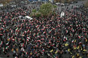 A group of demonstrators in Tehran wave Iranian flags in support of the government on Feb. 28, 2026 AP Photo/Vahid Salemi