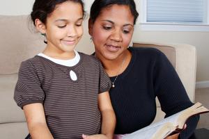 Woman and her daughter reading the Bible. Dreamstime/TCA