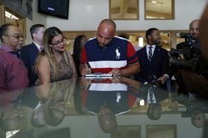 Javon Jackson, center, was able to register to vote following passage of a 2019 Nevada law that restored voting rights to formerly incarcerated individuals. AP Photo/John Locher