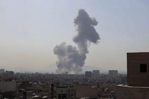 TOPSHOT - A plume of smoke rises following a reported explosion in Tehran on February 28, 2026. Two loud blasts were heard in Tehran on February 28 morning by AFP journalists, and two plumes of thick smoke were seen over the centre and east of the Iranian capital. Israel's defence ministry announced it had launched a 