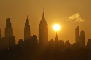 The sun rises over New York City as a heat wave arrives in June 2025. Gary Hershorn/Getty Images