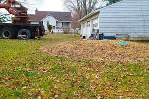 The green discs visible in the straw are service lids to a septic tank that was installed too high. As a result of this preventable error, the sewage line from the house to the tank did not have the required pitch called for in the plumbing code. (Tim Carter/Tribune Content Agency/TNS)