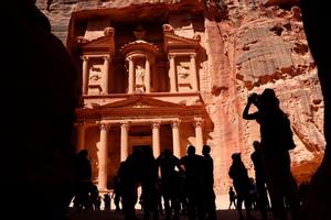 Tourists take pictures of the Khazneh (Treasury) in Jordan's ancient city of Petra on May 5, 2017. Established as the capital city of the Nabataeans, the rose rock city is Jordan's most popular touristic site and was chosen as one of the seven New Wonders of the World in 2007. / AFP PHOTO / THOMAS COEX (Photo credit should read THOMAS COEX/AFP via Getty Images)