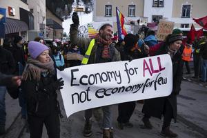 Demonstrators arrive for a protest ahead of the World Economic Forum in Davos, Switzerland, on Jan. 19, 2025.  AP Photo/Markus Schreiber