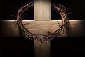 Crown of thorns and wooden cross. Crown of thorns hanging on wooden cross. Dreamstime/TCA
