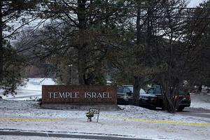 Law enforcement vehicles are seen parked outside Temple Israel guarding the scene in West Bloomfield, Michigan, on March 13, 2026, after a person identified as Ayman Ghazali drove a vehicle into the building. A 41-year-old man was killed on March 12 after ramming his pickup truck into a synagogue on the outskirts of Detroit, Michigan, causing a blaze and triggering a huge police response. (Photo by JEFF KOWALSKY / AFP via Getty Images)