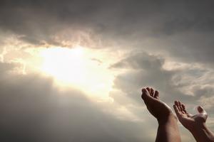 praying hands of a man for blessings his god on the sunset. Dreamstime/TCA