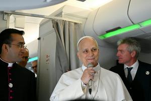 Pope Leo XIV speaks to journalists aboard his flight bound for Algiers on April 13, 2026.  Alberto Pizzoli/Pool Photo via AP
