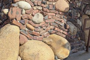 This is a small brick and stone retaining wall. The mason used some factory-reject bricks to create it. It’s also possible these curved and twisted bricks were made on purpose. (Tim Carter/Tribune Content Agency/TNS)