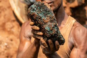 An artisanal miner holds a cobalt stone at a mine near Kolwezi, Congo, in 2022. About 20,000 people work there among toxic materials. Junior Kannah/AFP via Getty Images