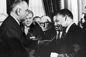 President Lyndon Johnson hands a pen to civil rights leader Rev. Martin Luther King Jr. during the signing of the Voting Rights Act in Washington,  D.C., on Aug. 6, 1965.  Hulton Archive, Washington Bureau/Getty Images