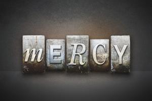 The word MERCY written in vintage letterpress type. Dreamstime/TCA