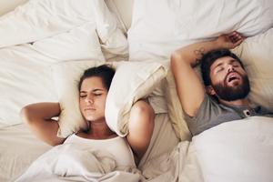 Snoring can be − but isn't always − a symptom of sleep apnea.  PeopleImages/iStock via Getty Images