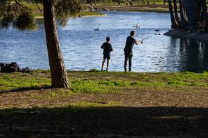 Fishing is recreational, but it's also an inexpensive way to add protein to people's diets. Allen J. Schaben / Los Angeles Times via Getty Images