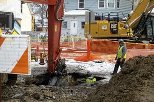 Workers repair a water pipeline that dates back to the 1930s. In the coming years, utility bills in Detroit are likely to rise to pay for upgrades to aging infrastructure.  Jim West/UCG/Universal Images Group via Getty Images