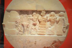 An ancient disk shows the priestess Enheduanna, third figure from the right, during a ritual. Mefman00/Wikimedia Commons, CC BY