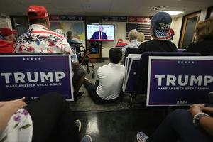 Phoenix residents watch presidential candidate Donald Trump speak at the Republican National Convention on July 18, 2024. AP Photo/Ross D. Franklin